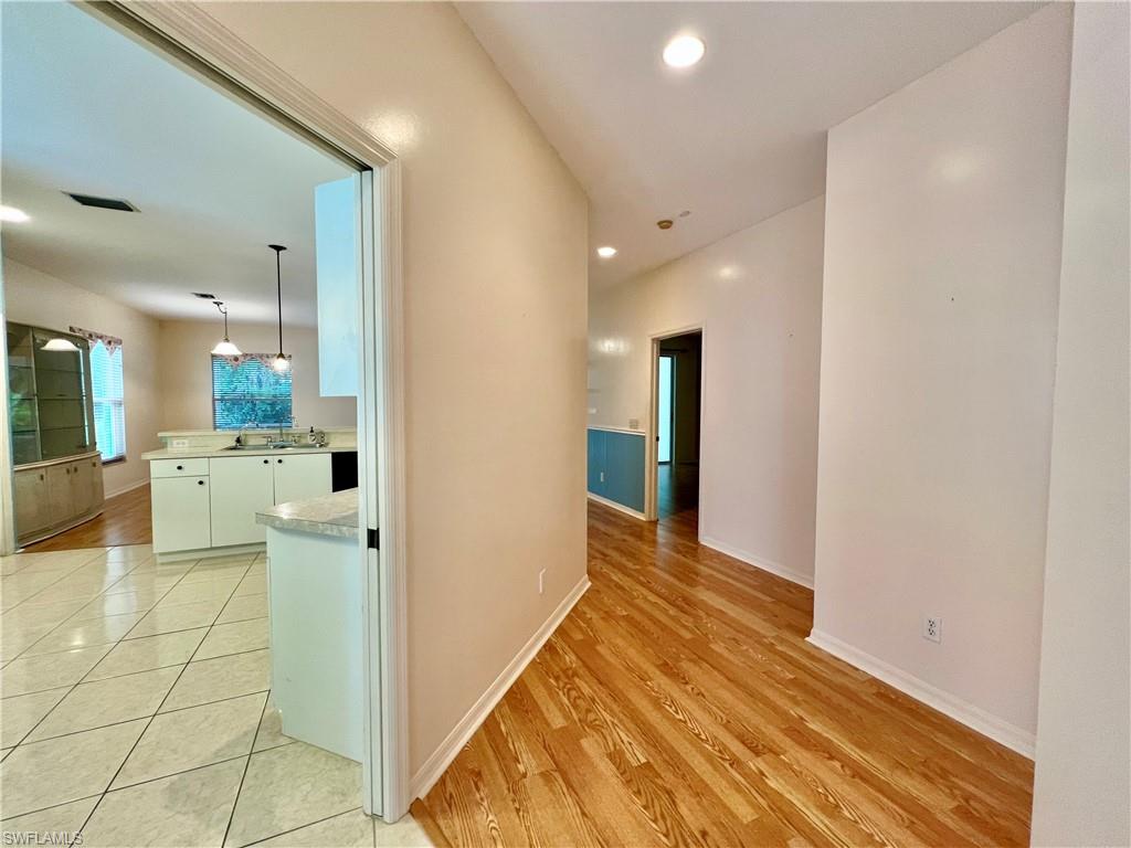 443 Crossfield Circle, Unit 74 Naples, FL 34104 - Photo 5 of 45 a view of a hallway with a kitchen