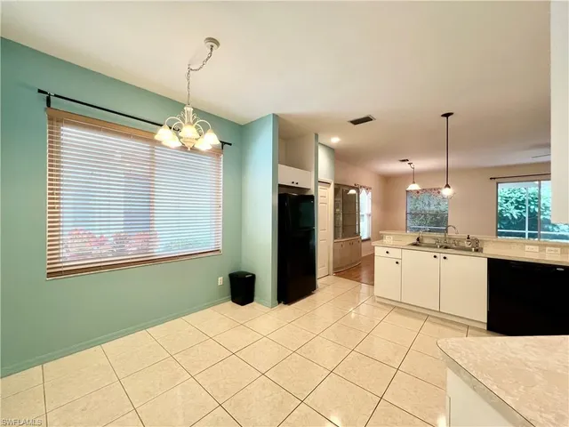 a kitchen with a refrigerator a oven a stove top oven and a large window