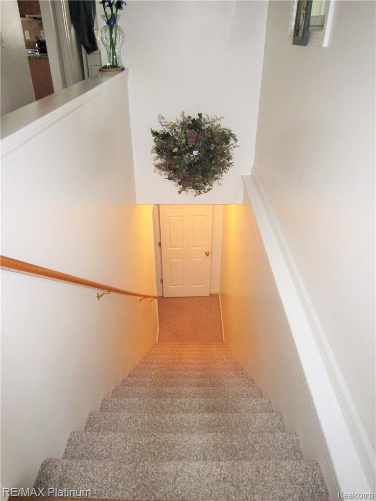 7011 Oak Grove Road Howell, MI 48855 - Photo 18 of 30 Open staircase leads to lower level