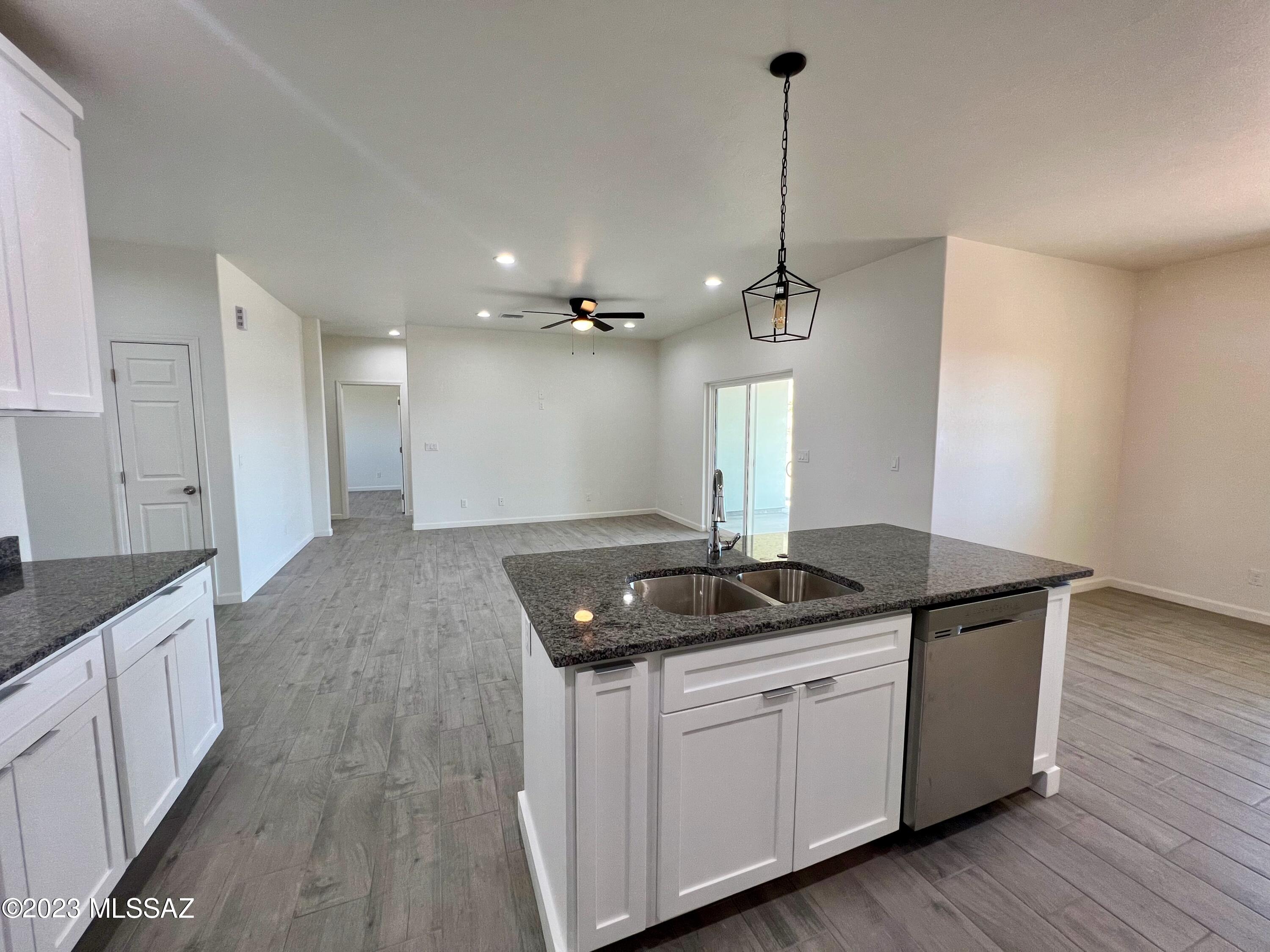 353 Dock Street Rio Rico, AZ 85648 - Photo 28 of 50 a kitchen with sink refrigerator and cabinets