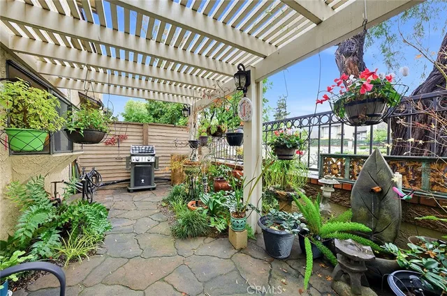 a view of a porch with furniture and a potted plant