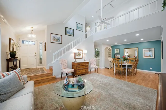 a living room with furniture and a dining table with kitchen view