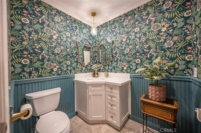 a bathroom with a toilet a sink and a mirror