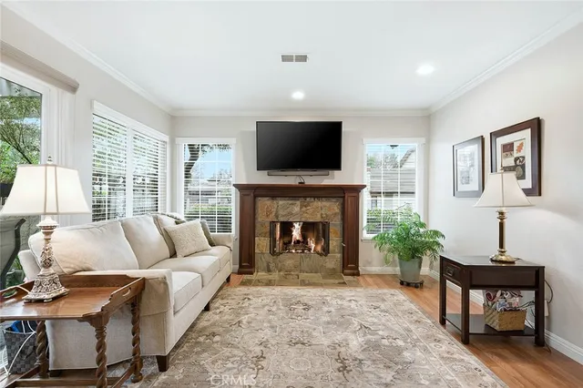 a living room with furniture a flat screen tv and a fireplace