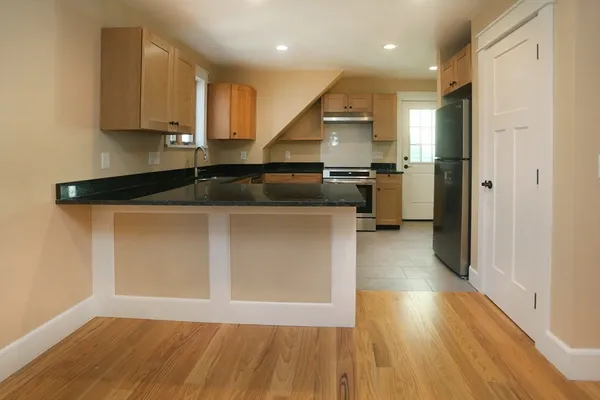 a kitchen with kitchen island a counter top space a sink and stainless steel appliances
