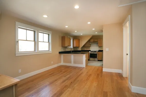 a view of kitchen with cabinets and wooden floor