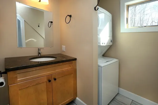a bathroom with a sink a light fixture and a mirror