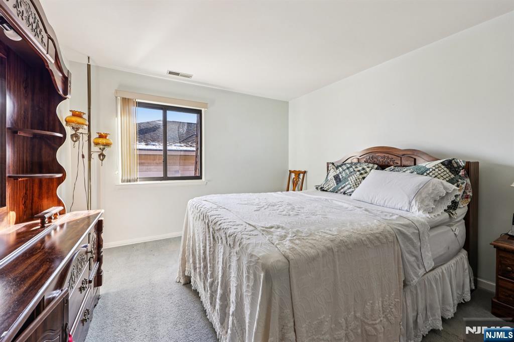 825 Riverside Avenue, Unit 207 Lyndhurst, NJ 07071 - Photo 11 of 18 a bedroom with a bed and a window