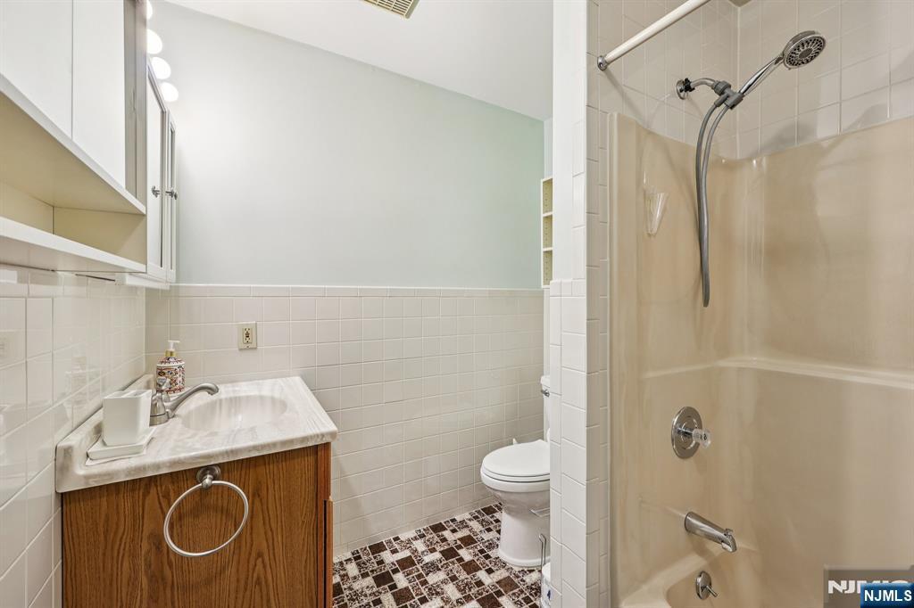 825 Riverside Avenue, Unit 207 Lyndhurst, NJ 07071 - Photo 15 of 18 a bathroom with a sink a toilet and shower