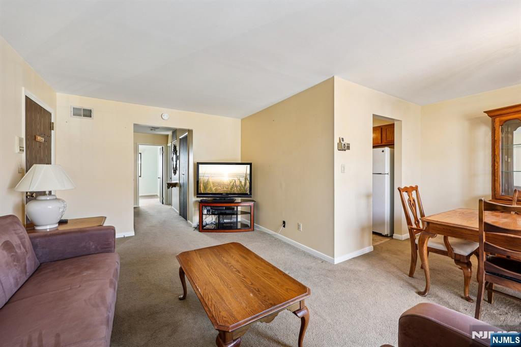 825 Riverside Avenue, Unit 207 Lyndhurst, NJ 07071 - Photo 5 of 18 a living room with furniture and a flat screen tv