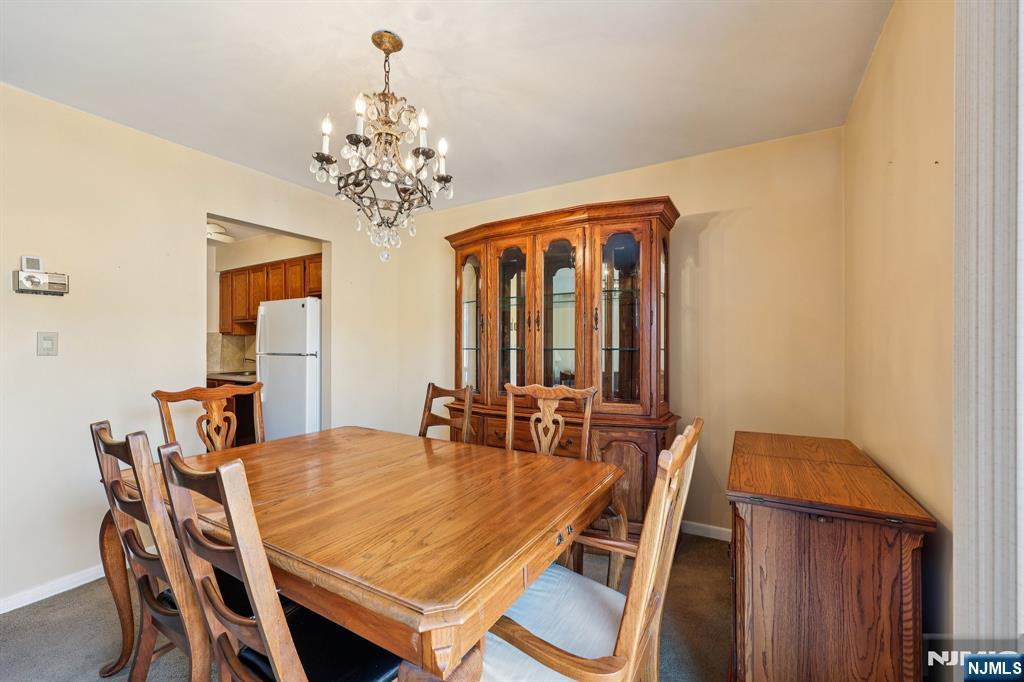 825 Riverside Avenue, Unit 207 Lyndhurst, NJ 07071 - Photo 6 of 18 a dining room with furniture and chandelier