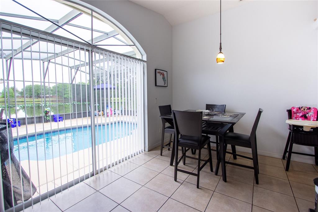 1832 Wimbledon Street Kissimmee, FL 34743 - Photo 11 of 39 a view of a dining room with furniture and a potted plant