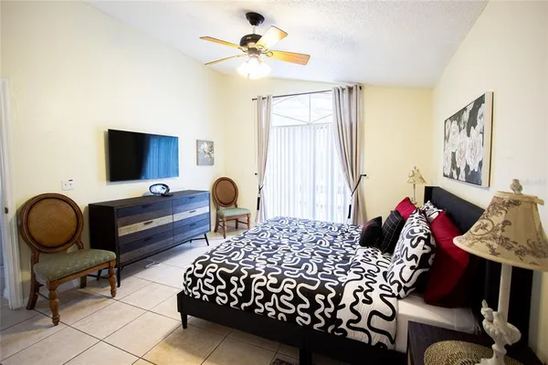 a bedroom with a bed and a chandelier