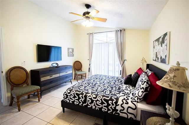 a bedroom with a bed and a chandelier