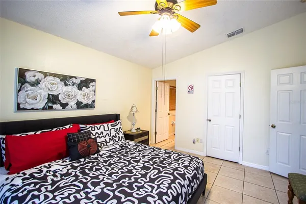 a bedroom with a bed and a painting on the wall