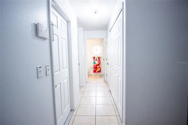 a bedroom with bed and a chandelier
