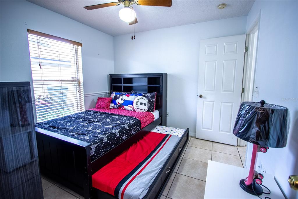 1832 Wimbledon Street Kissimmee, FL 34743 - Photo 22 of 39 a bedroom with a bed and a window