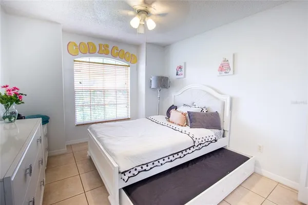 a bedroom with a bed and flat screen tv
