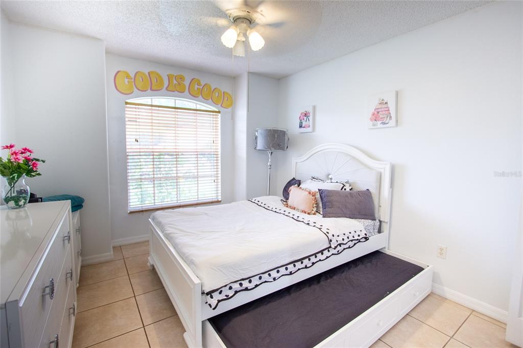 1832 Wimbledon Street Kissimmee, FL 34743 - Photo 24 of 39 a bedroom with a bed and a window