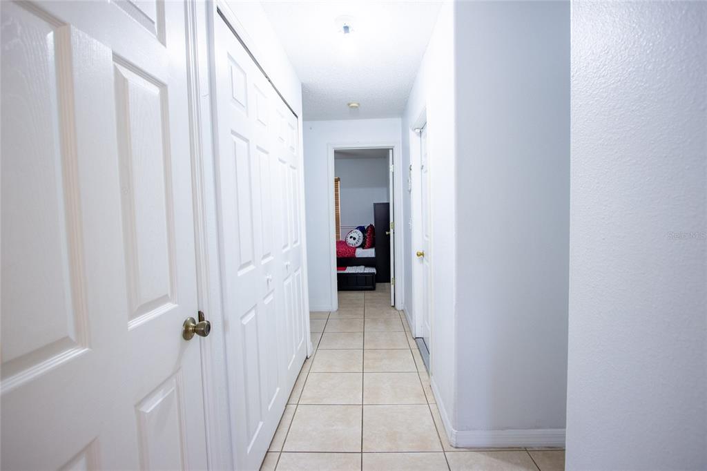 1832 Wimbledon Street Kissimmee, FL 34743 - Photo 27 of 39 a view of a hallway with wooden shelves