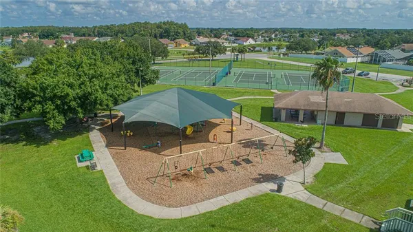 a view of an house with backyard space and porch