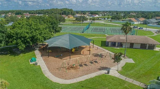 a view of an house with backyard space and porch