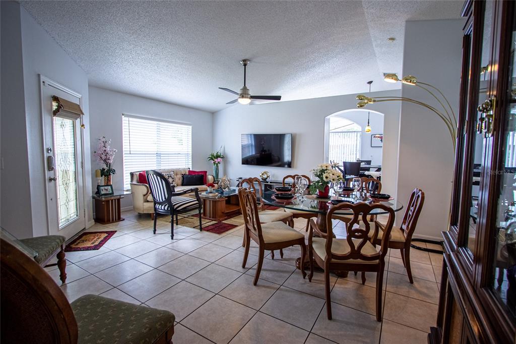 1832 Wimbledon Street Kissimmee, FL 34743 - Photo 8 of 39 a view of a livingroom with furniture and a flat screen tv