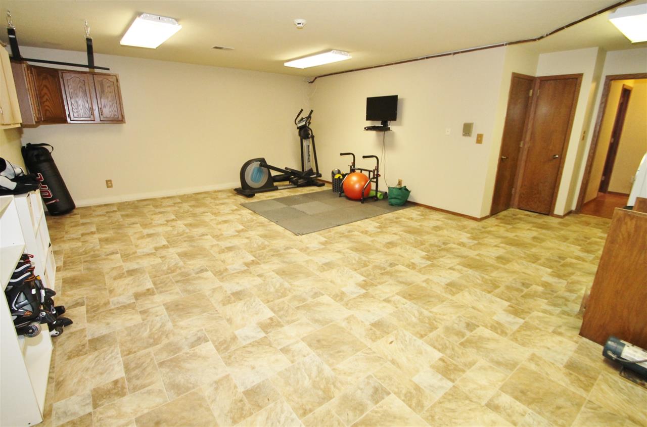 8212 Snaresbrook Road Roscoe, IL 61073 - Photo 23 of 25 a room with a bed and a flat screen tv