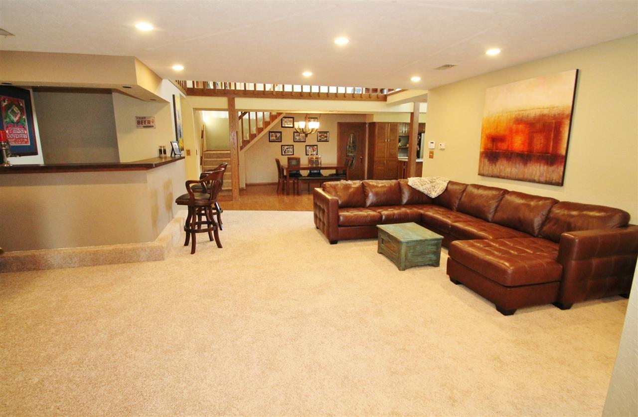 8212 Snaresbrook Road Roscoe, IL 61073 - Photo 3 of 25 a living room with furniture and a flat screen tv