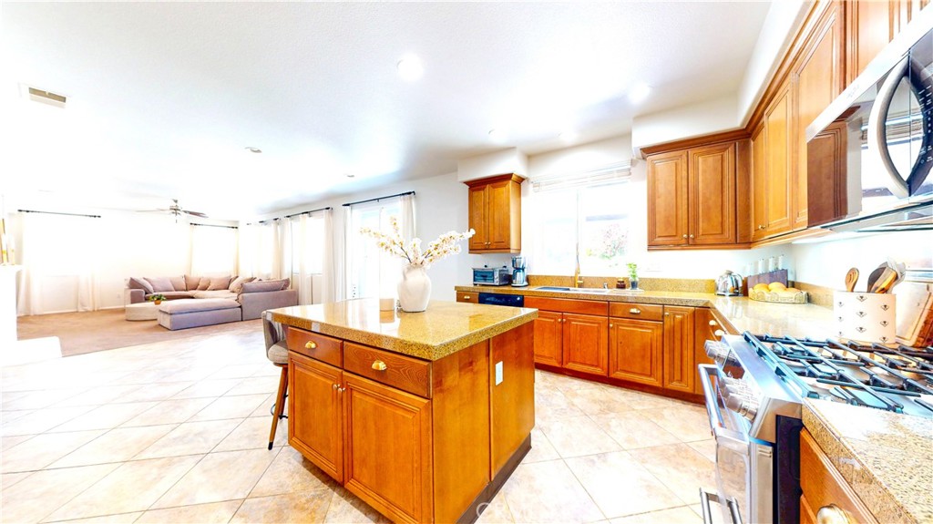 1279 Longbranch Road San Jacinto, CA 92582 - Photo 9 of 35 a kitchen with sink a stove and cabinets