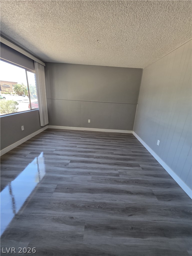 1089 East Desert Inn Road, Unit 3 Las Vegas, NV 89109 - Photo 5 of 15 Naturally illuminated, this room features durable wood-look flooring and a window offering views of the exterior.