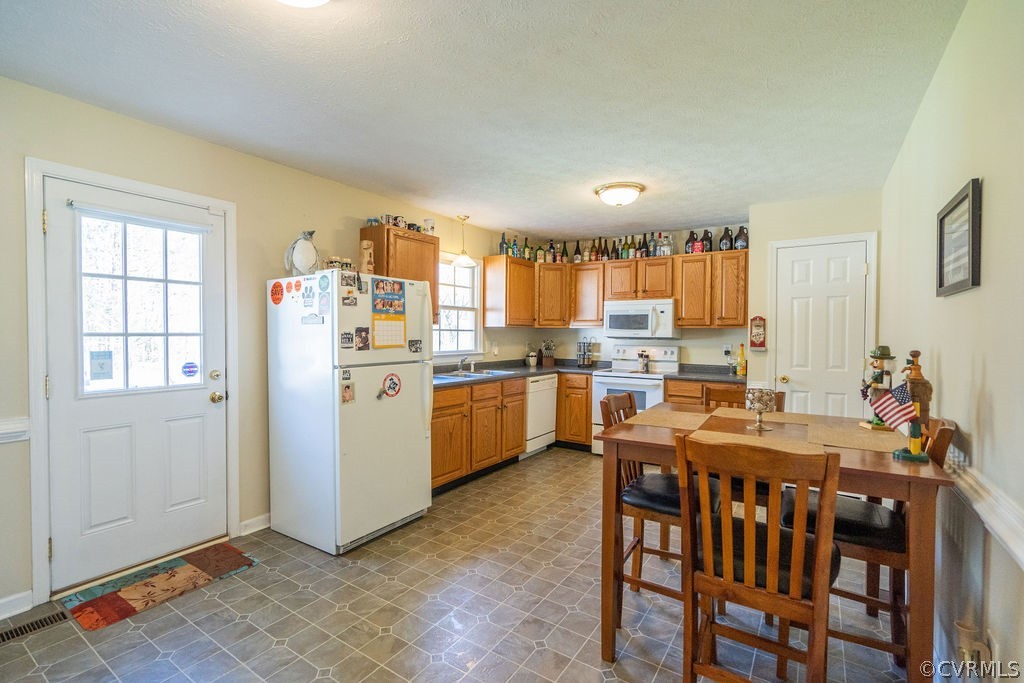 8681 Strath Road Henrico, VA 23231 - Photo 14 of 29 a kitchen that has a lot of cabinets in it and appliances