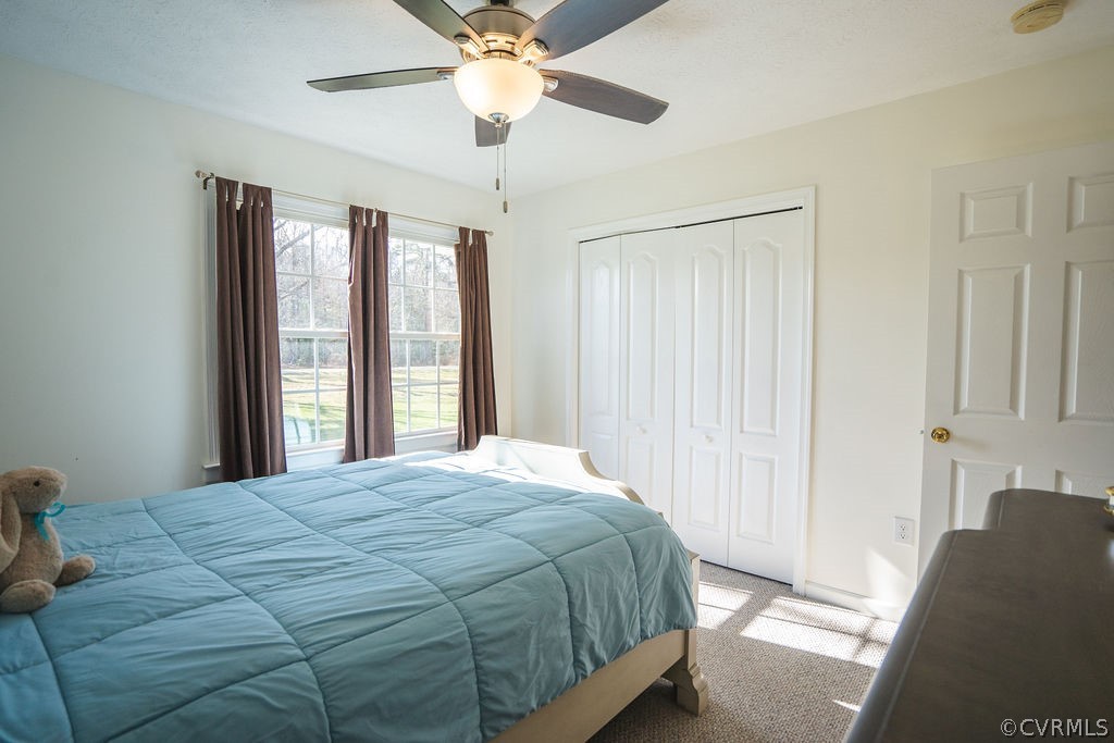 8681 Strath Road Henrico, VA 23231 - Photo 23 of 29 a bedroom with a large bed and a chandelier