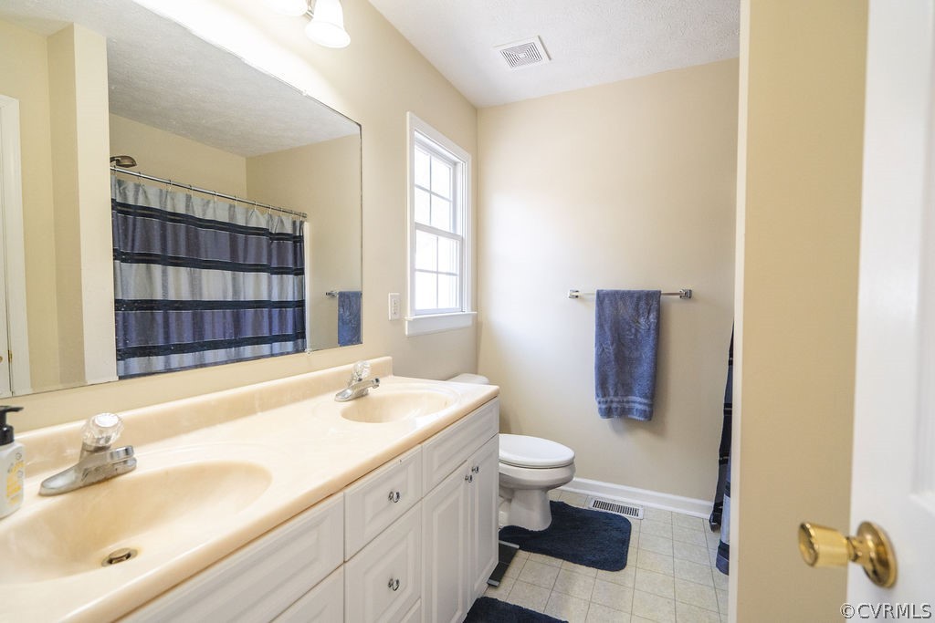 8681 Strath Road Henrico, VA 23231 - Photo 26 of 29 a bathroom with a sink a toilet and shower