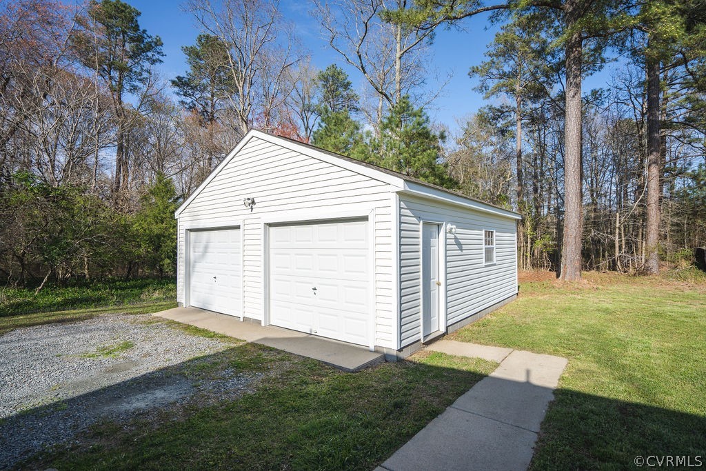 8681 Strath Road Henrico, VA 23231 - Photo 8 of 29 a view of a white house with a yard and large trees