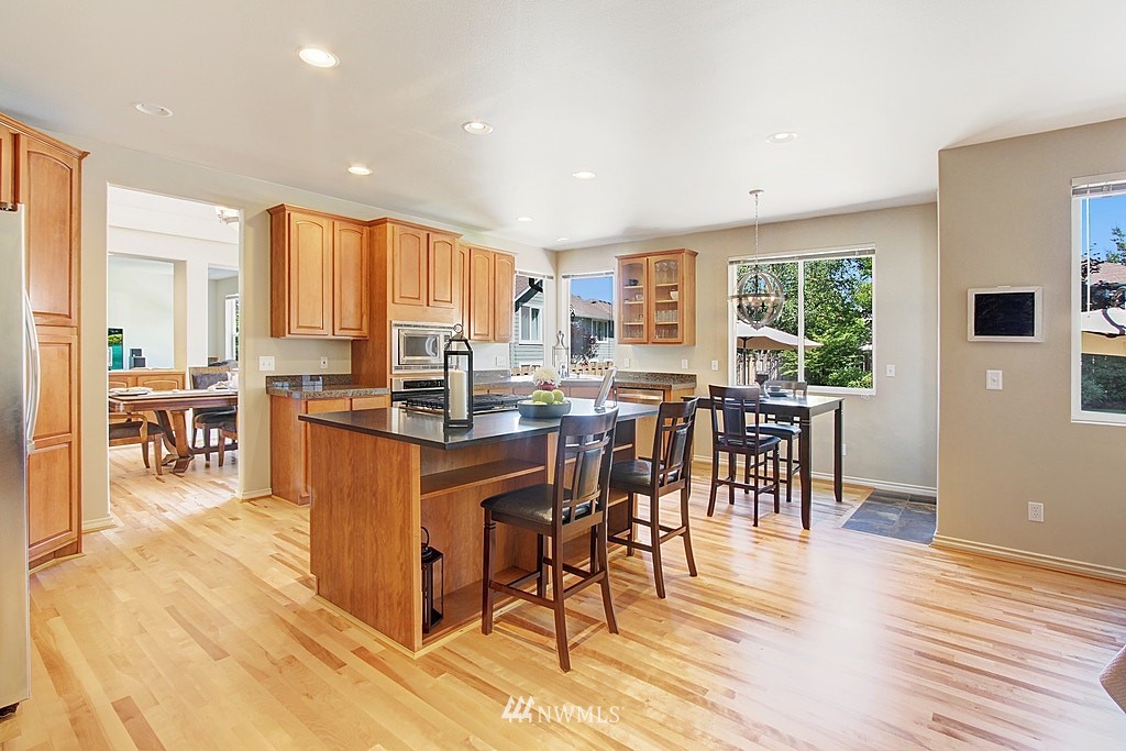 27712 Maple Ridge Way Southeast Maple Valley, WA 98038 - Photo 11 of 36 a view of a dining room with furniture window and wooden floor