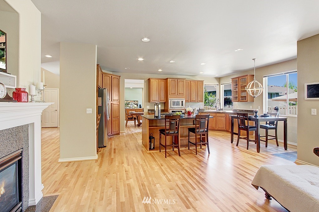 27712 Maple Ridge Way Southeast Maple Valley, WA 98038 - Photo 15 of 36 a view of a dining room with furniture and wooden floor