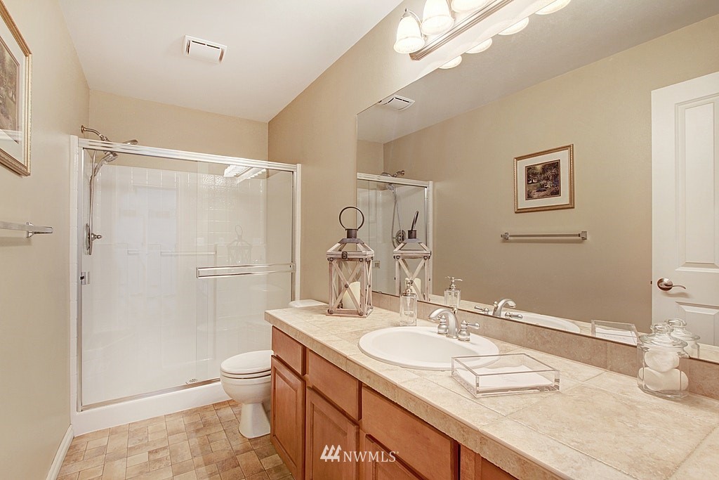 27712 Maple Ridge Way Southeast Maple Valley, WA 98038 - Photo 17 of 36 a bathroom with a granite countertop sink mirror vanity and toilet