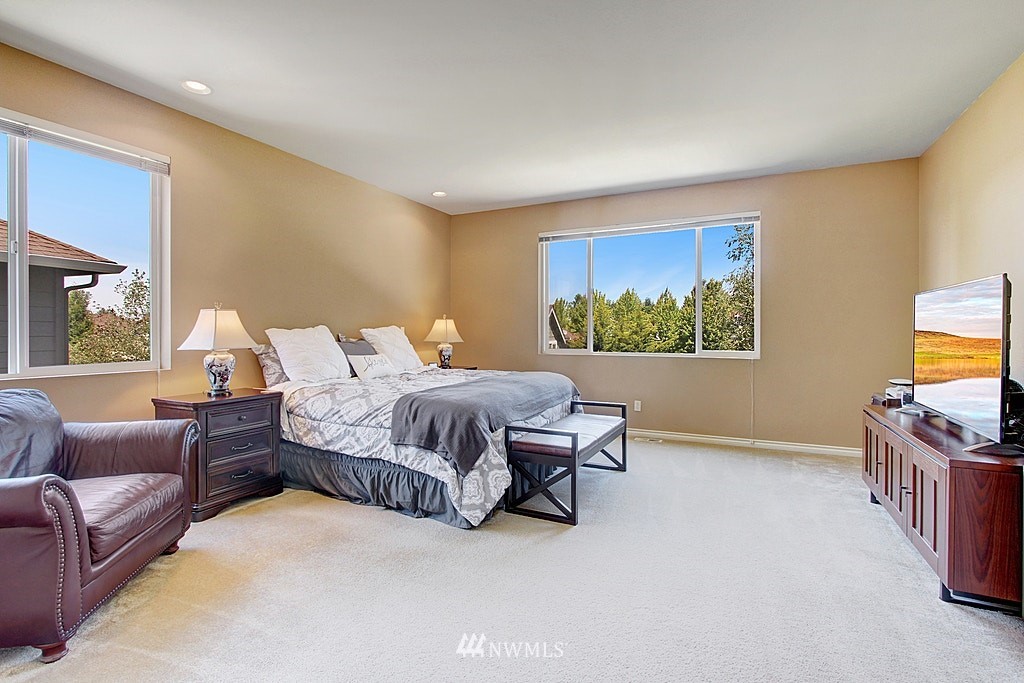 27712 Maple Ridge Way Southeast Maple Valley, WA 98038 - Photo 20 of 36 a bedroom with a bed couch and window