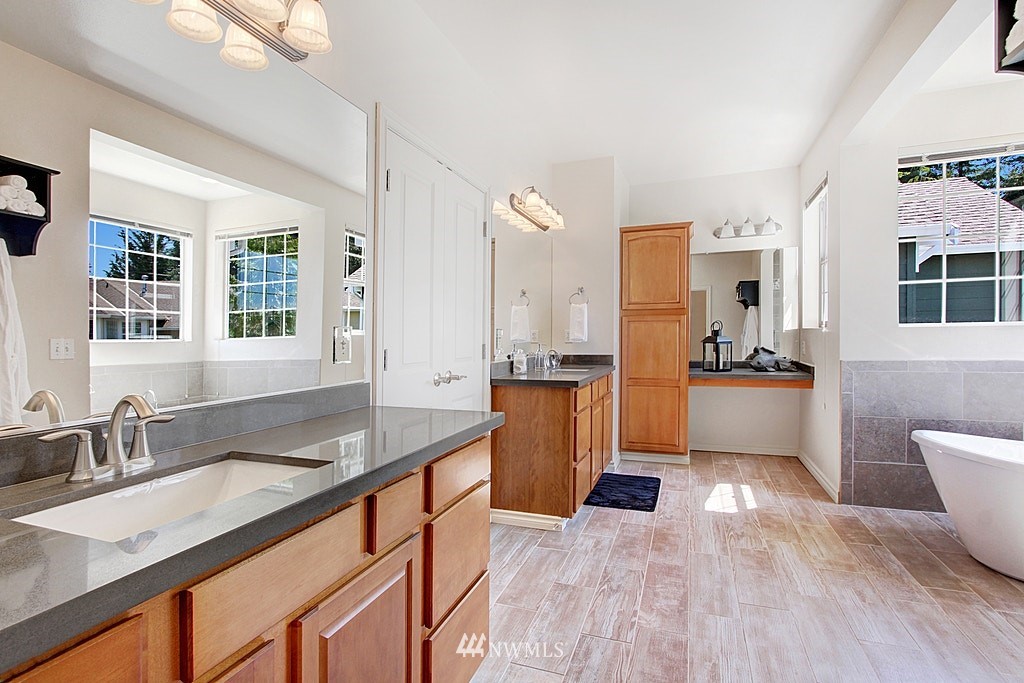 27712 Maple Ridge Way Southeast Maple Valley, WA 98038 - Photo 23 of 36 a kitchen with granite countertop a sink and wooden floor