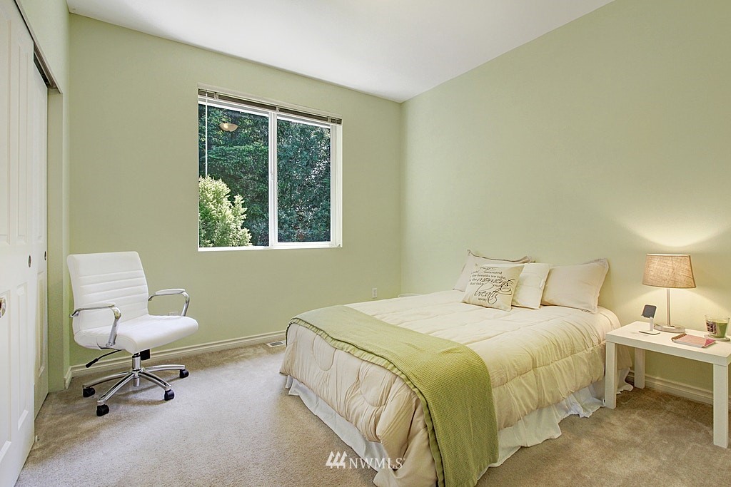 27712 Maple Ridge Way Southeast Maple Valley, WA 98038 - Photo 24 of 36 a bedroom with a bed a table and a window