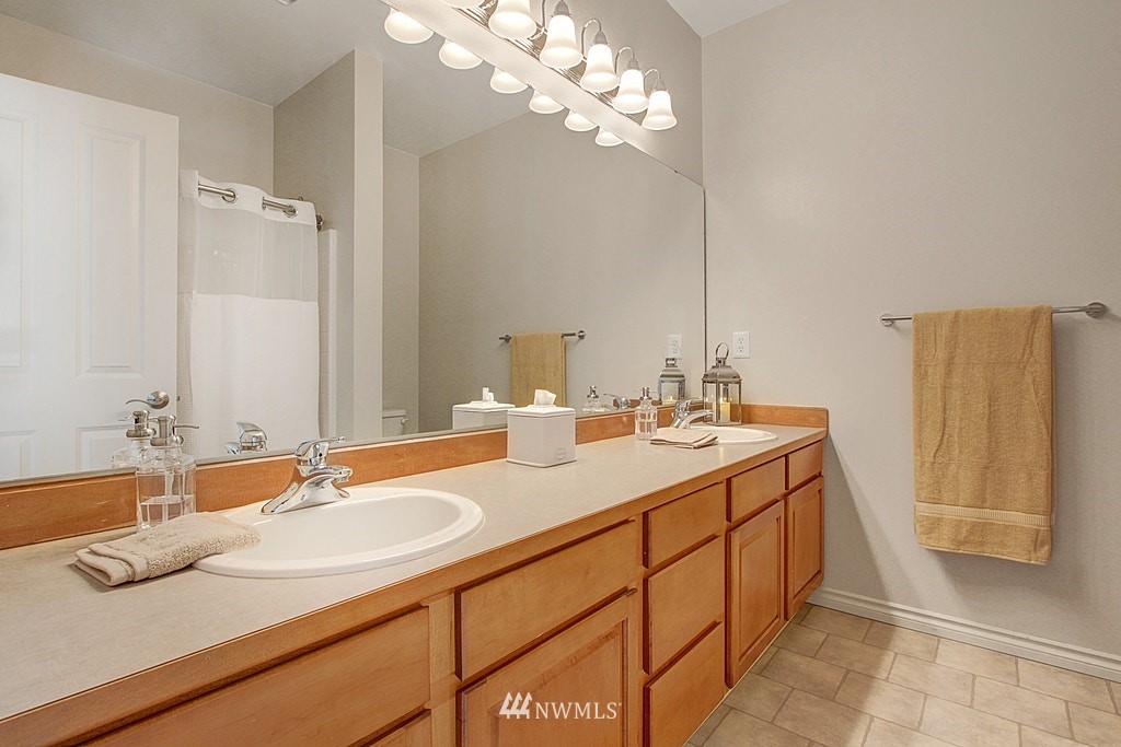 27712 Maple Ridge Way Southeast Maple Valley, WA 98038 - Photo 26 of 36 a bathroom with a sink and a mirror
