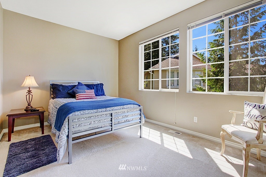 27712 Maple Ridge Way Southeast Maple Valley, WA 98038 - Photo 27 of 36 a bedroom with a bed and a window