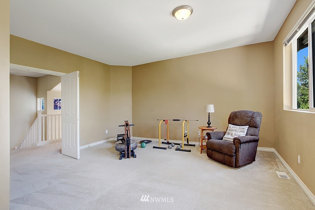 27712 Maple Ridge Way Southeast Maple Valley, WA 98038 - Photo 29 of 36 a living room with furniture and a flat screen tv