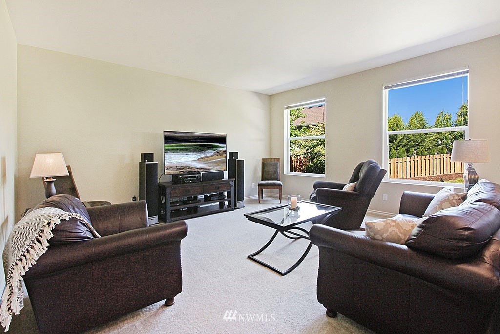 27712 Maple Ridge Way Southeast Maple Valley, WA 98038 - Photo 10 of 36 a living room with furniture a large window and a flat screen tv