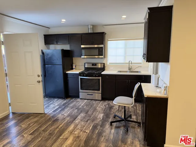 a kitchen with a sink stainless steel appliances and cabinets