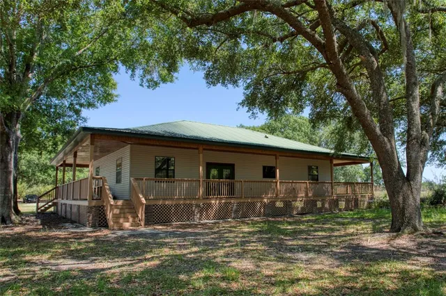 a view of backyard of house with green space