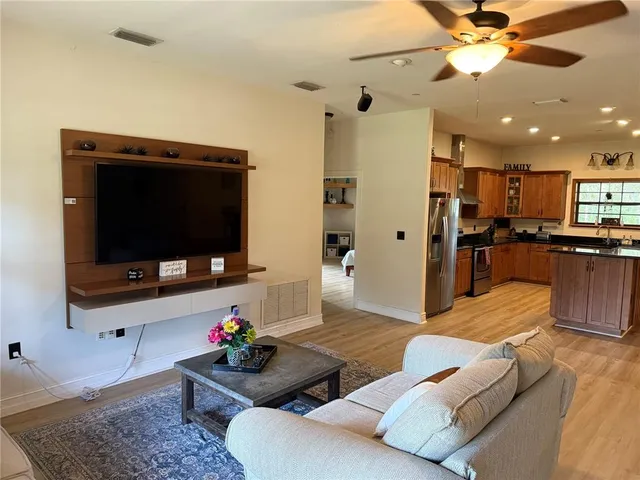 a kitchen with stainless steel appliances granite countertop a refrigerator and a stove top oven