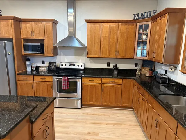a kitchen with granite countertop a stove and a cabinets