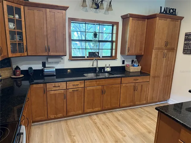 a kitchen with stainless steel appliances granite countertop a refrigerator and a stove top oven